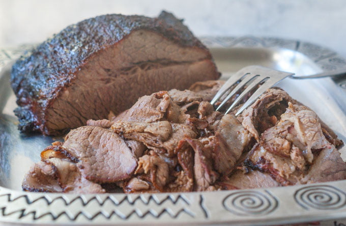 sliced smoked barbecue brisket on  a platter 