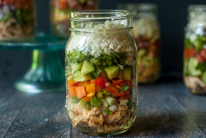 Asian chicken salad in a jar with other jars in the background