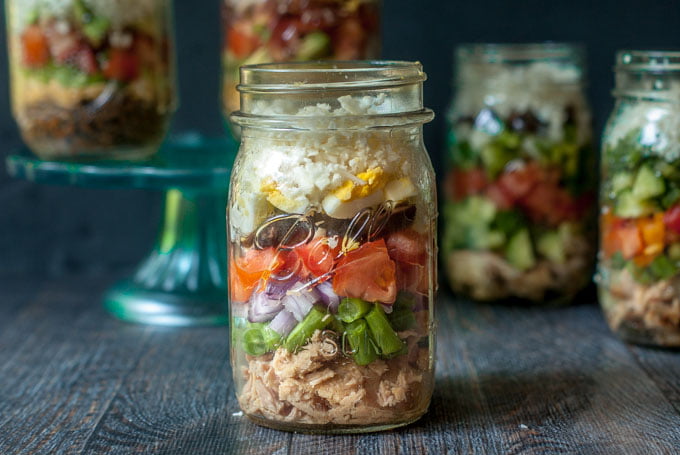 Nicoise Tuna salad in a jar with other jars in the background