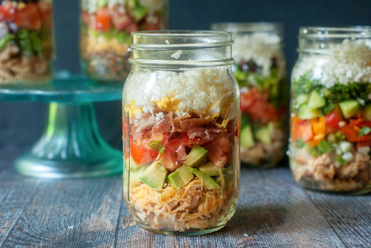 Closeup of a keto high protein Cobb salad in a mason jar.