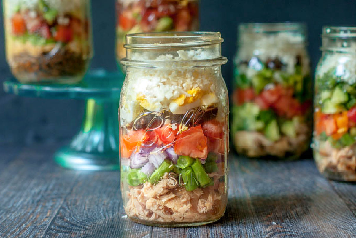 Closeup of a keto hit protein  Nicoise salad in a mason jar for meal prep.