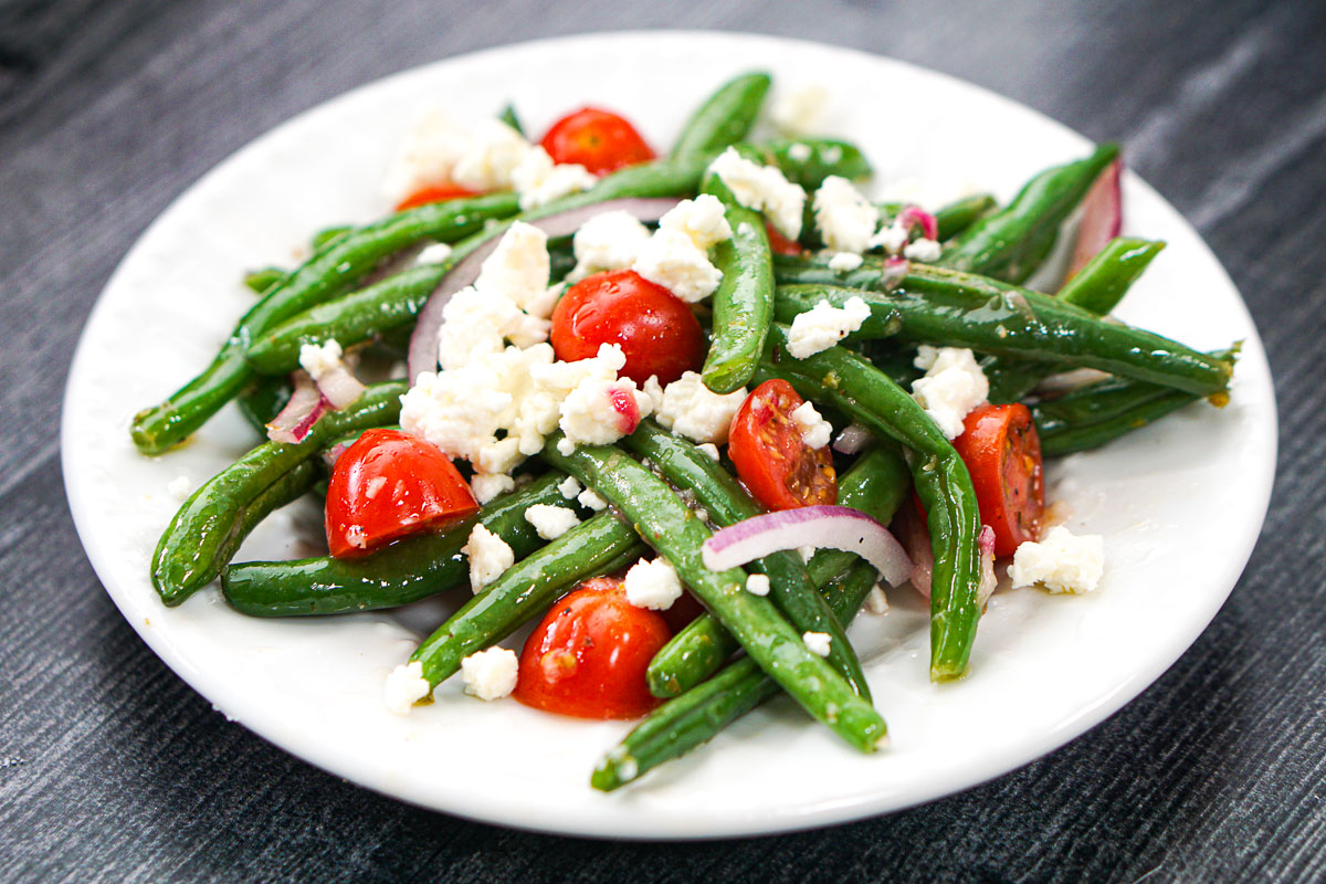 white plate with a close up of the green bean salad