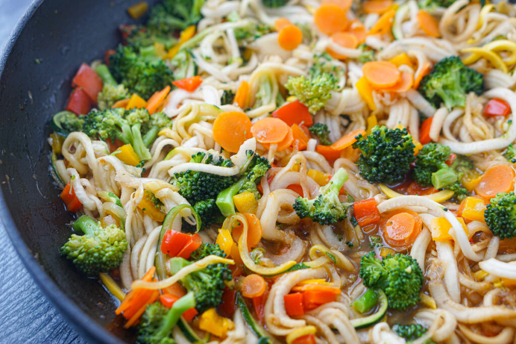 closeup of a pan with vegetable stir fryer and turnip noodles