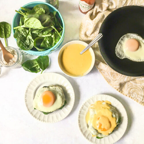 Aerial view of portobello eggs Benedict with hollandaise sauce and fresh spinach.