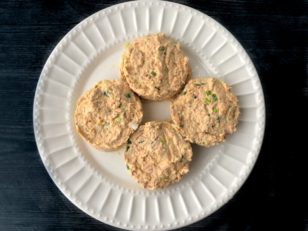 white plate with 4 low carb patties ready to fry