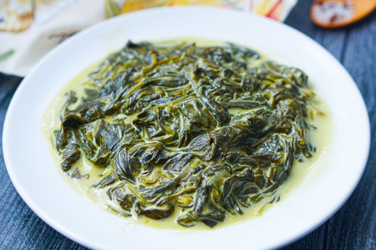 closeup of a plate of cooked spinach with cheese