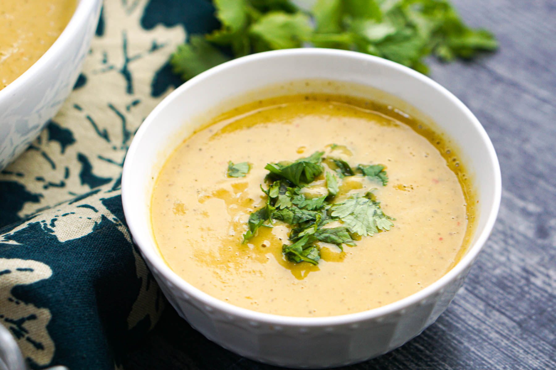 Thai Curry Zucchini Soup - you can make this tasty soup in the Instant Pot or slow cooker. A great way to use all that zucchini from the garden. Closeup of the finished soup with some fresh cilantro on top.