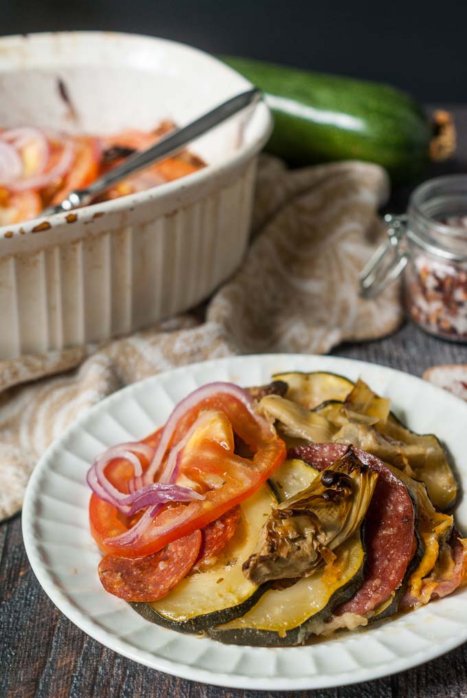 This garden zucchini antipasto casserole is the perfect dish to make with all of those huge zucchini you get from your garden this summer. Layers of zucchini, meats and cheeses are topped with artichokes, tomatoes and onions. 