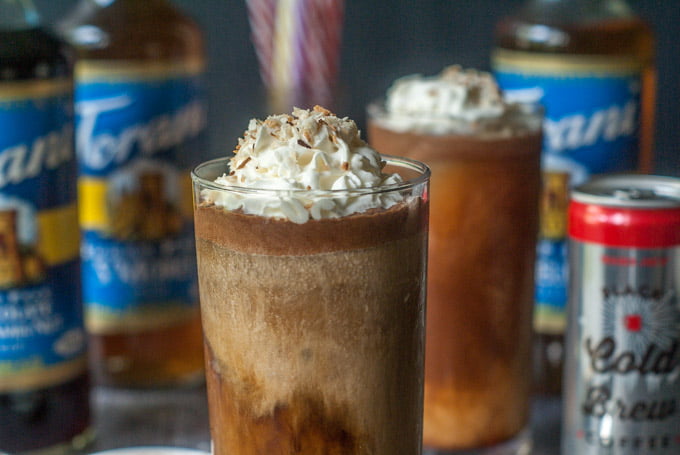 German chocolate cake low carb coffee drink with coconut whipped cream and Torani syrup bottles in background