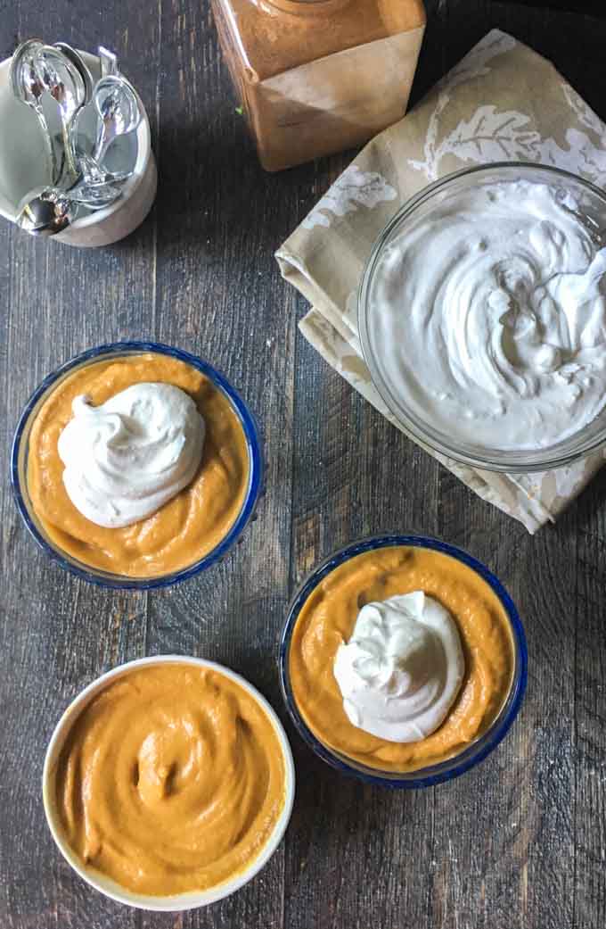 aerial view of pumpkin pie pudding and a dish of coconut whipped cream