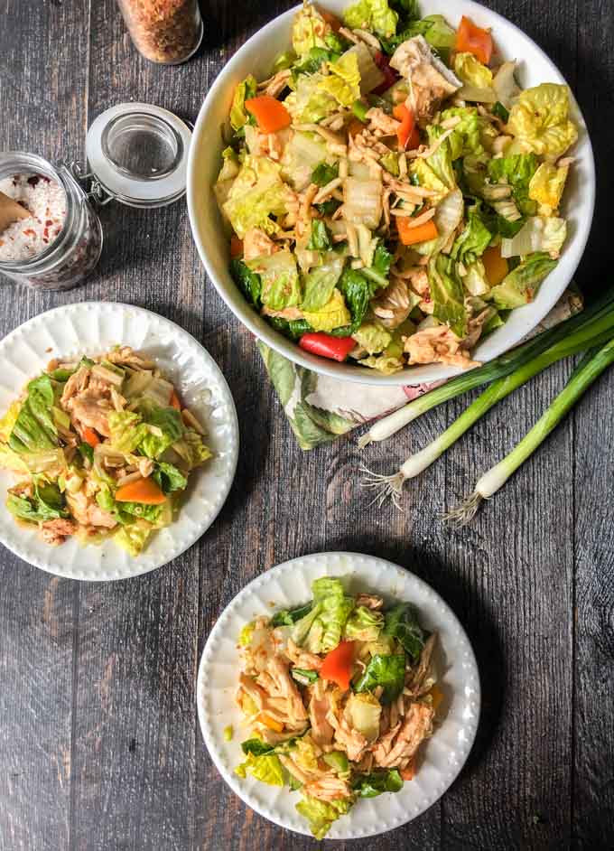 bowl of Chinese chicken salad  and smaller white plates with it too