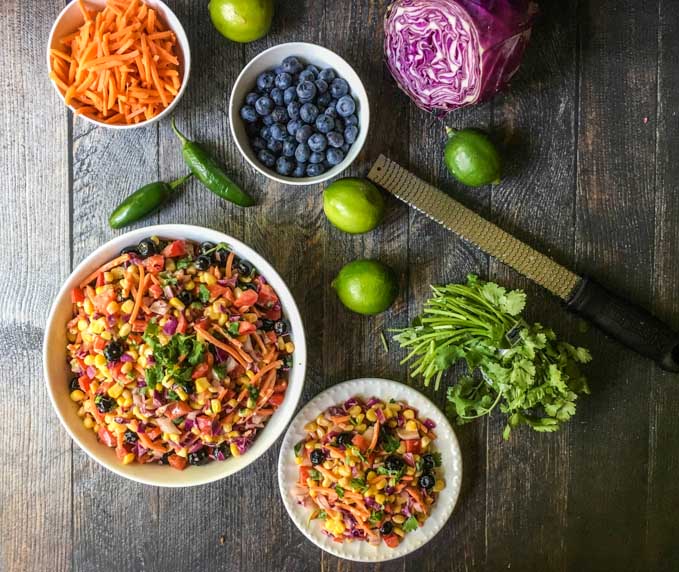 This rainbow Mexican corn salad is a tasty twist on Mexican corn. Colorful vegetables and fruit are tossed in a creamy lime dressing for the perfect sweet and tangy salad. A beautiful and tasty side dish for picnics and parties.