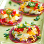 Closeup of a green platter with keto salami tostada bites.