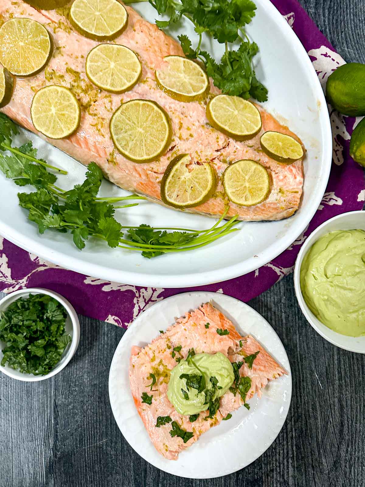 Aerial view of a platter and plate with the margarita salmon filet and fresh cilantro.