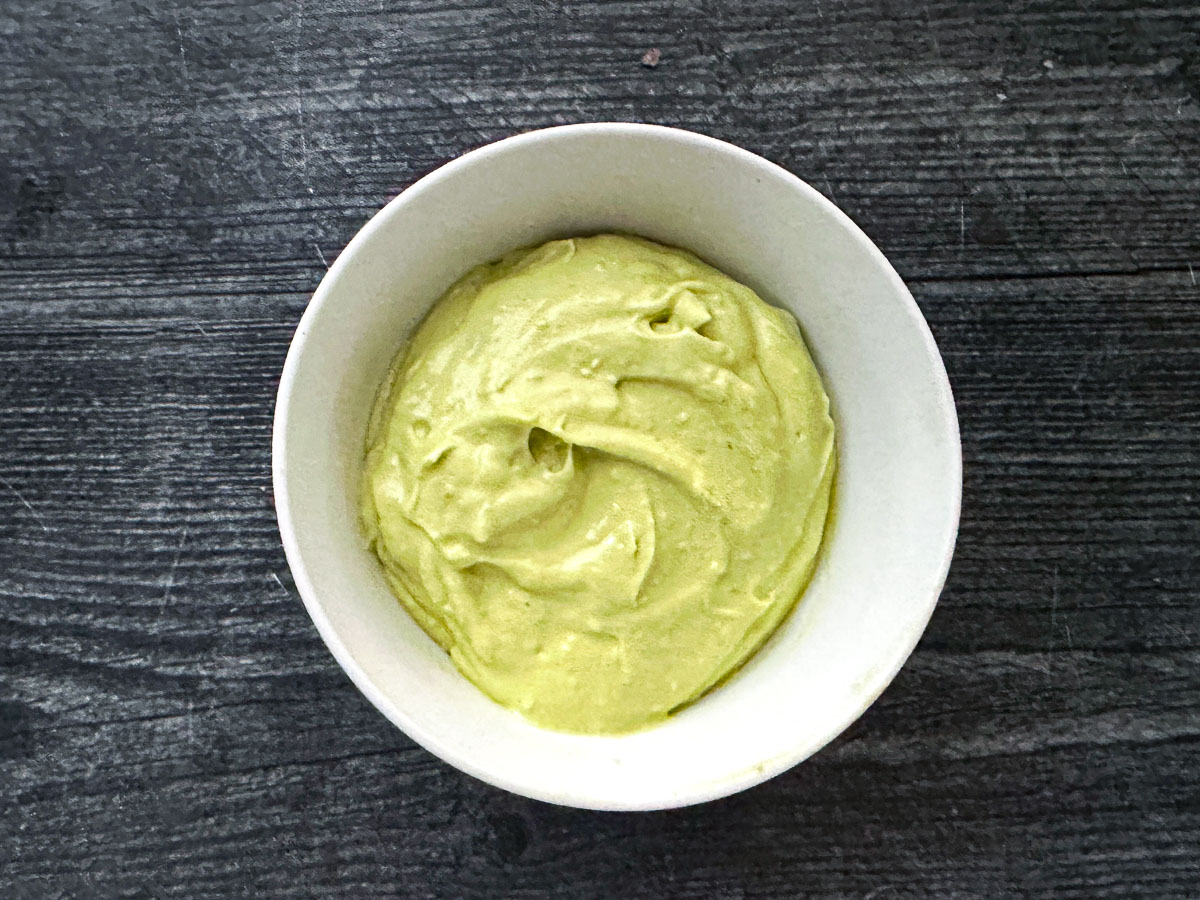 White bowl with creamy avocado aioli dip.