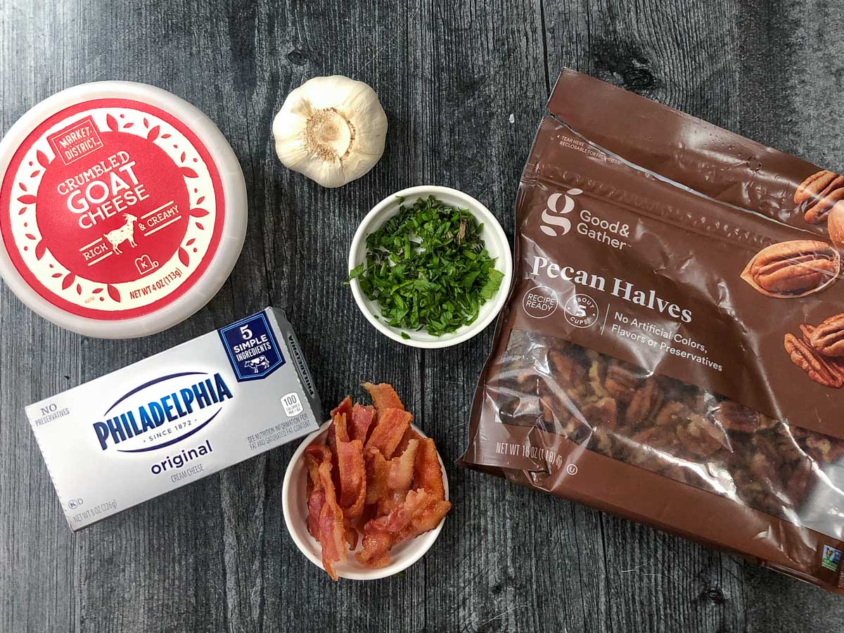 recipe ingredients - fresh garlic, fresh herbs, bacon, creamy cheese, goat cheese and pecans