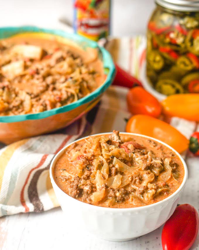 two bowls of Mexican low carb casserole and jar of jalapeños in background