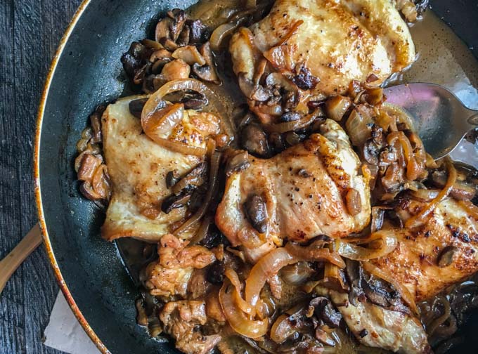 closeup of low carb chicken dinner n a skillet with balsamic onions and mushrooms