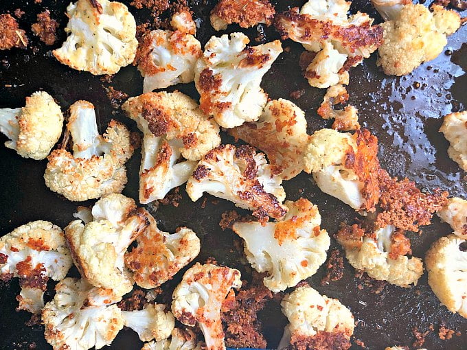 roasted cauliflower florets with parmesan on cookie sheet
