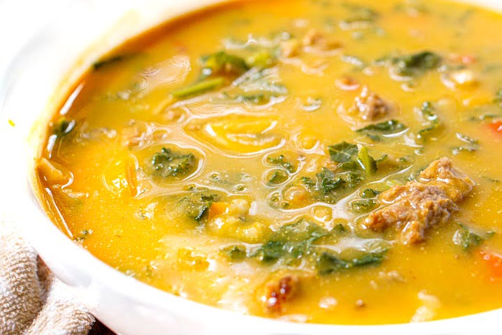 close up of soup showing kale and sausage in the pumpkin soup