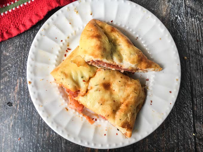 This low carb meat calzone is the perfect handheld pizza. Using fathead dough and tasty Italian meats you can make these calzones, quickly and easily. Only 5.7g net carbs per serving.