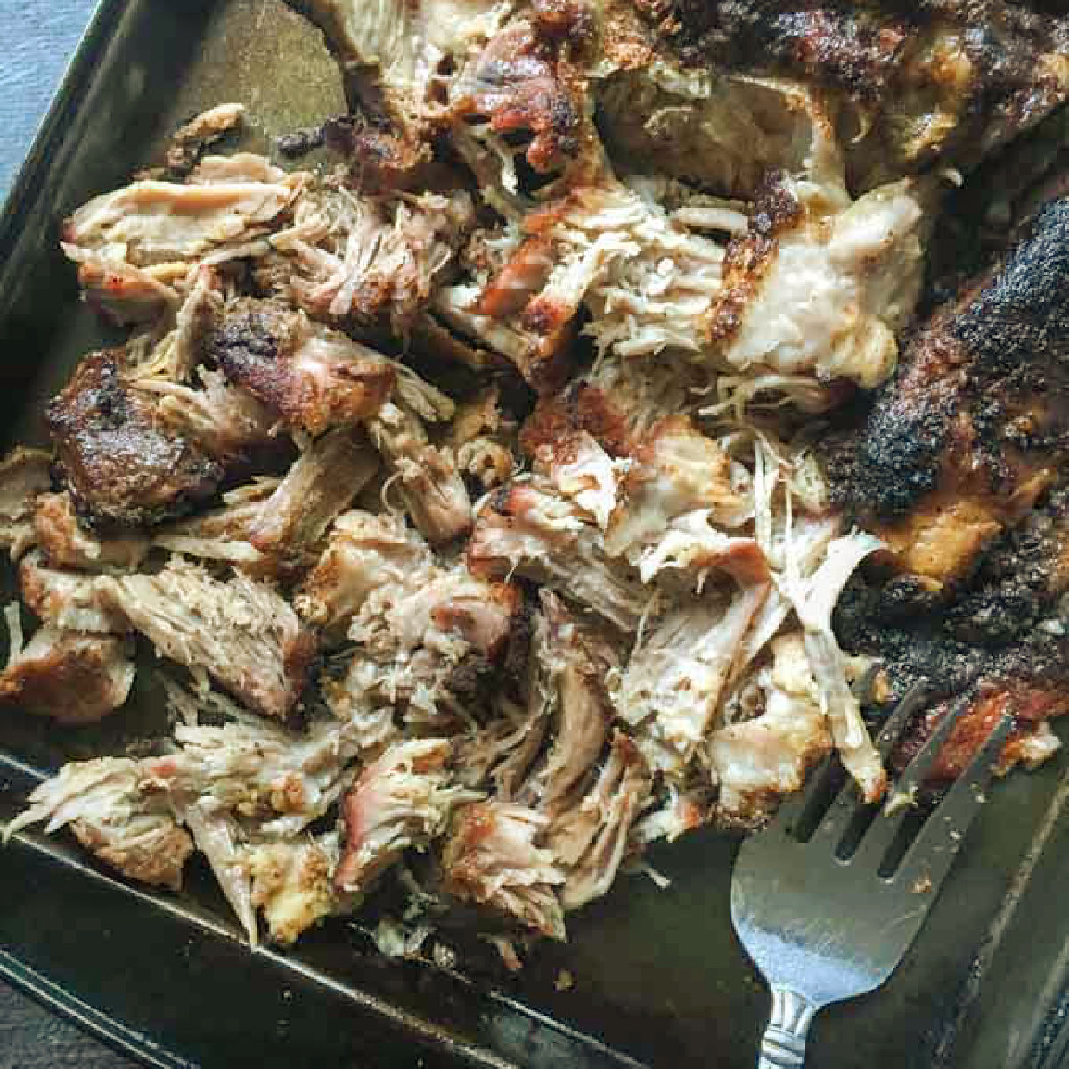 Slow Cooker Smokey Barbecue Pork - an easy low carb barbecue pork dish in the slow cooker! Aerial view of a baking sheet with the finished smoked pulled pork.