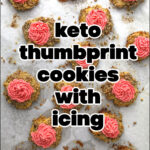 cookie sheet with keto thumbprint cookies with pink icing and text