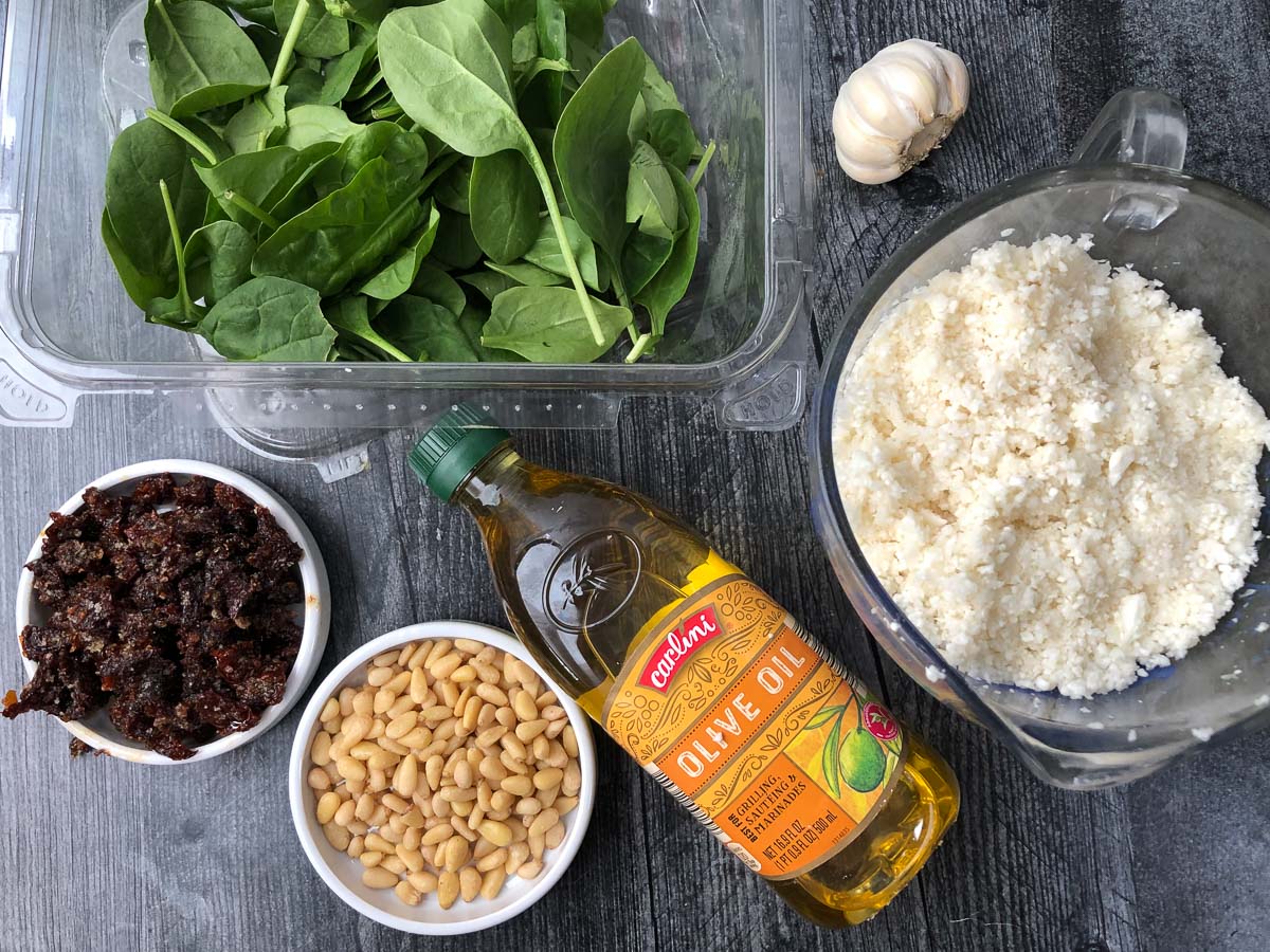 recipe ingredients spinach, sun dried tomatoes, pine nuts, olive oil, garlic and cauliflower rice