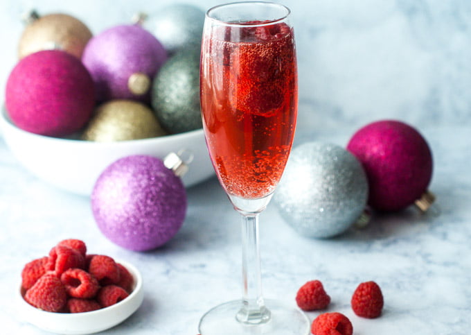 This low carb holiday raspberry mimosa is the perfect drink to sip on Christmas morning or New Year's eve. Lightly sweet and easy to make you will want to drink them all year round.