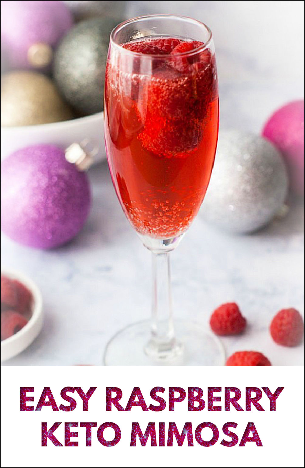 glass of raspberry mimosa drink with fresh raspberries and Christmas bulbs in the background with text