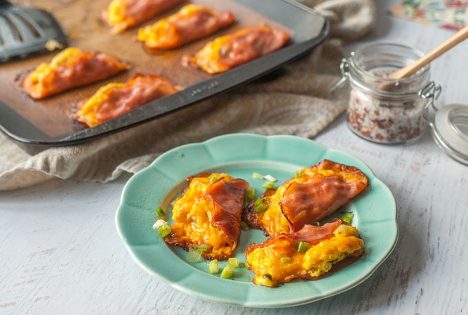 green plate and cookie sheet with low carb egg and ham breakfast tacos