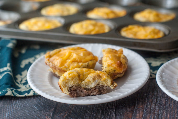 breakfast sausage egg cups on white plate and in muffin tin