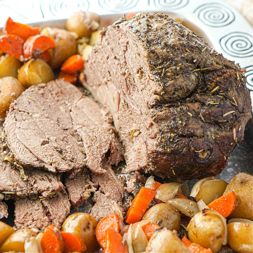 closeup of a lamb shoulder roast made in the slow cooker with potatoes and carrots
