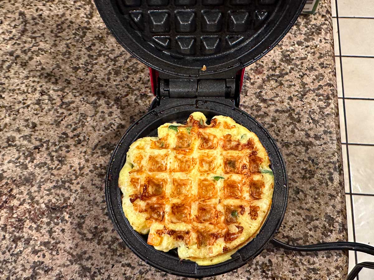 mini waffle maker with finished waffle in it