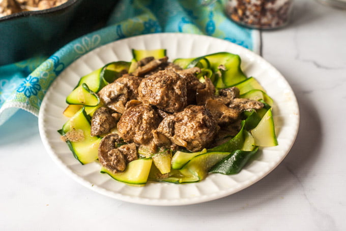 This low carb meatball stroganoff is the perfect way to top zucchini noodles. Creamy mushrooms sauce over beefy meatballs, you can even eat these as is or as an appetizer. 