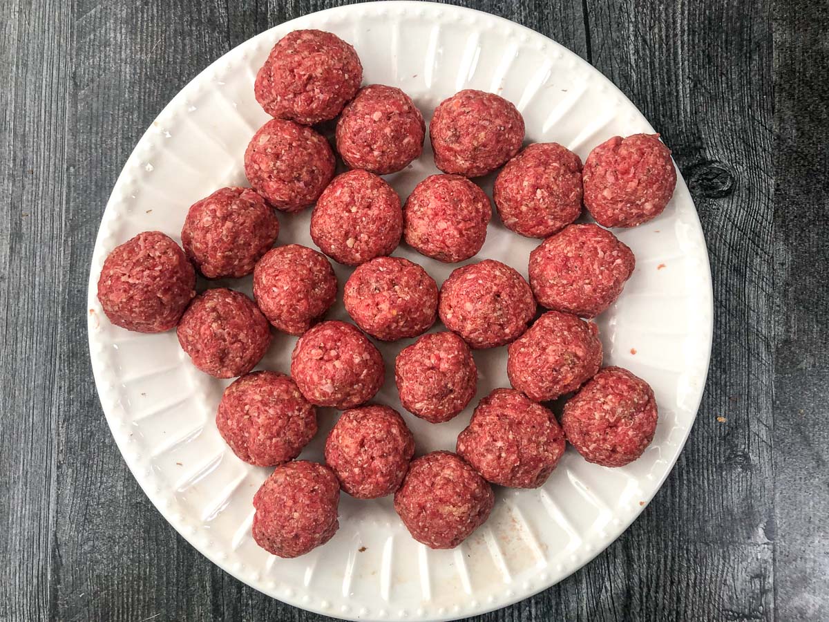 raw beef meatballs on a white plate