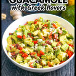Closeup of a bowl of Greek chunky guacamole dip and ingredients in the background and text overlay.