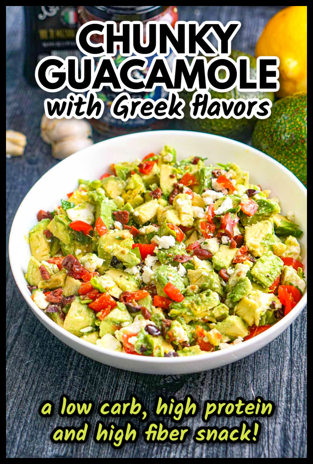 Closeup of a bowl of Greek chunky guacamole dip and ingredients in the background and text overlay.