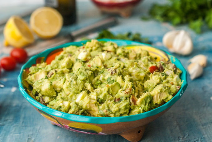 This chunky greek guacamole is a great low carb dip to take to a party or just add to your next Mexican feast. Briny olive, salty cheese, sweet tomatoes all wrapped up in creamy avocados. One serving is just 3.6g net carbs.