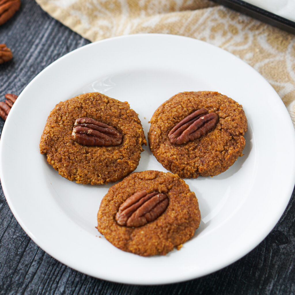 white plate with 3 pecan pumpkin keto cookies