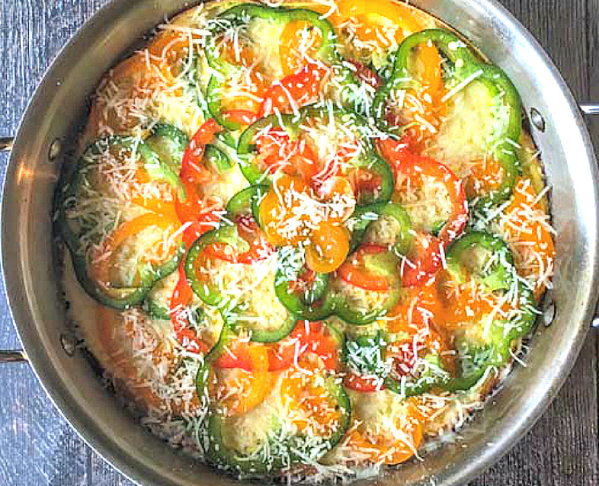 Oven safe pan with the egg dish ready to bake.