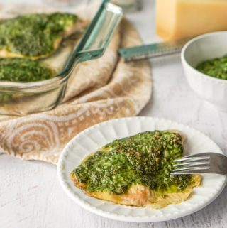 This low carb pesto tilapia dinner can be made in less than 20 minutes. The pesto is made from fresh spinach and toasted walnuts and adds lots of healthy color and flavor to this mild white fish. 