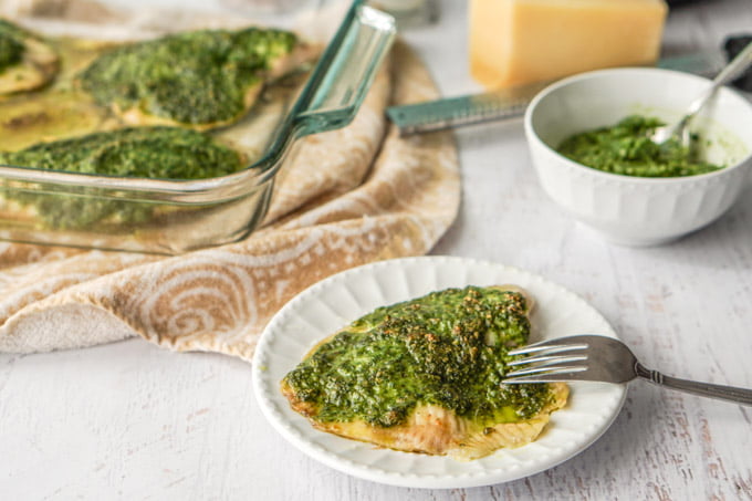 This low carb pesto tilapia dinner can be made in less than 20 minutes. The pesto is made from fresh spinach and toasted walnuts and adds lots of healthy color and flavor to this mild white fish. 