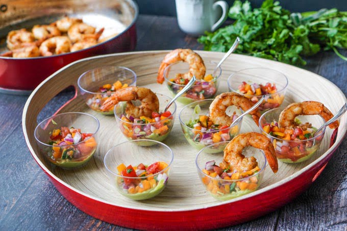 This Mexican shrimp cocktail is the perfect low carb appetizer for Cinco de Mayo! Each cup is filled with a creamy avocado dip, refreshing pico de gallo and 2 large spicy shrimp. Each serving has only 2.0g net carbs. 