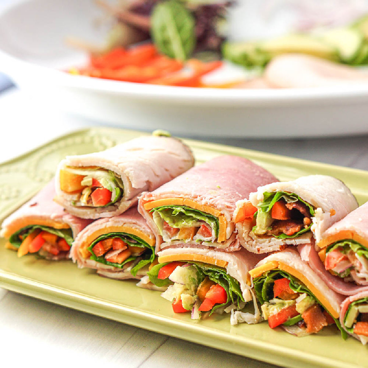 a platter with keto lunch meat wraps in a stack
