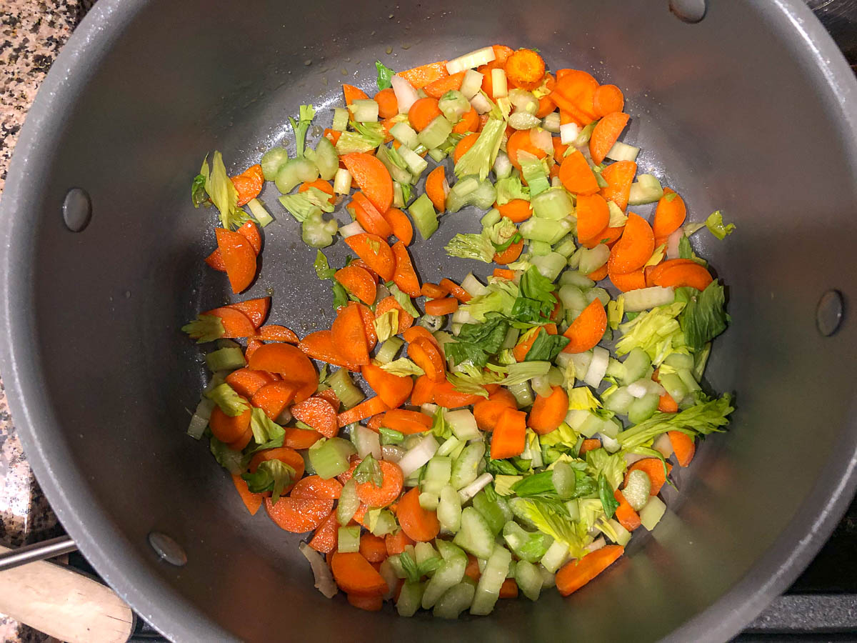 soup pan with chopped celery and carrots 