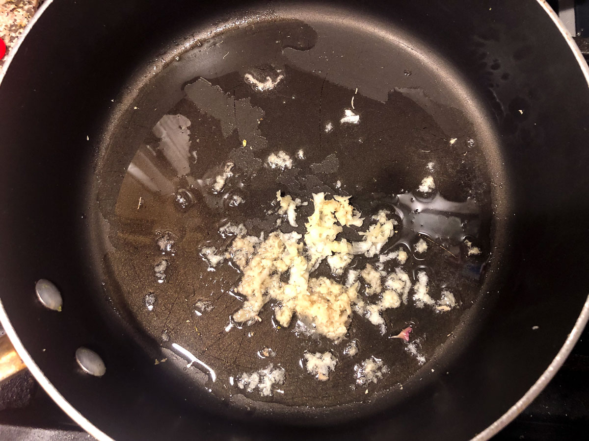 skillet with coconut oil, garlic and ginger