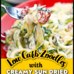 Closeup of a forkful of the keto zoodles with creamy sun dried tomato sauce and text overlay.