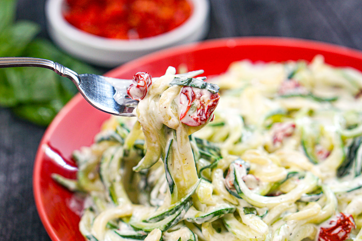 Closeup of a forkful of the creamy keto zoodles.