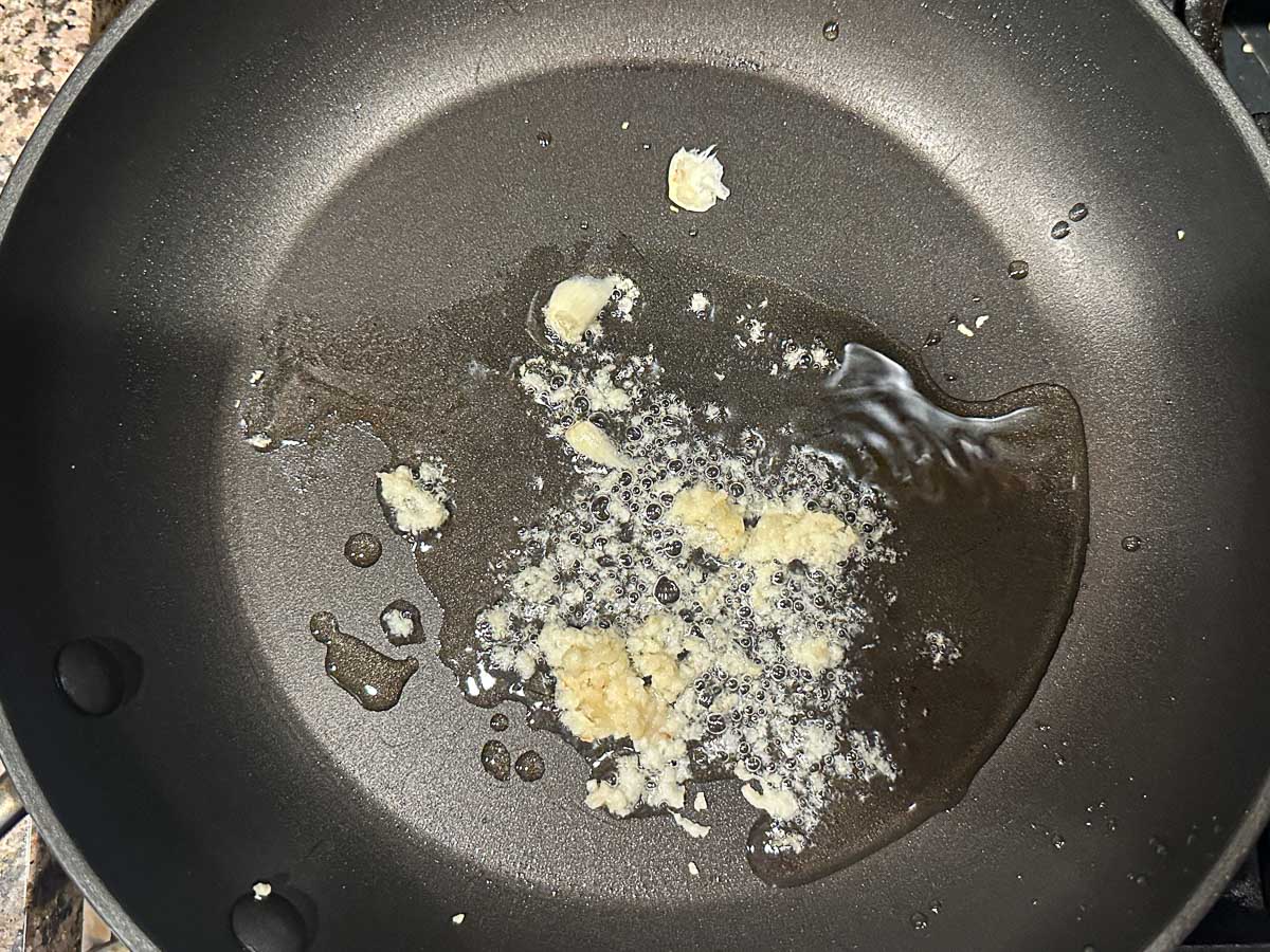 Saute pan with olive oil and garlic.